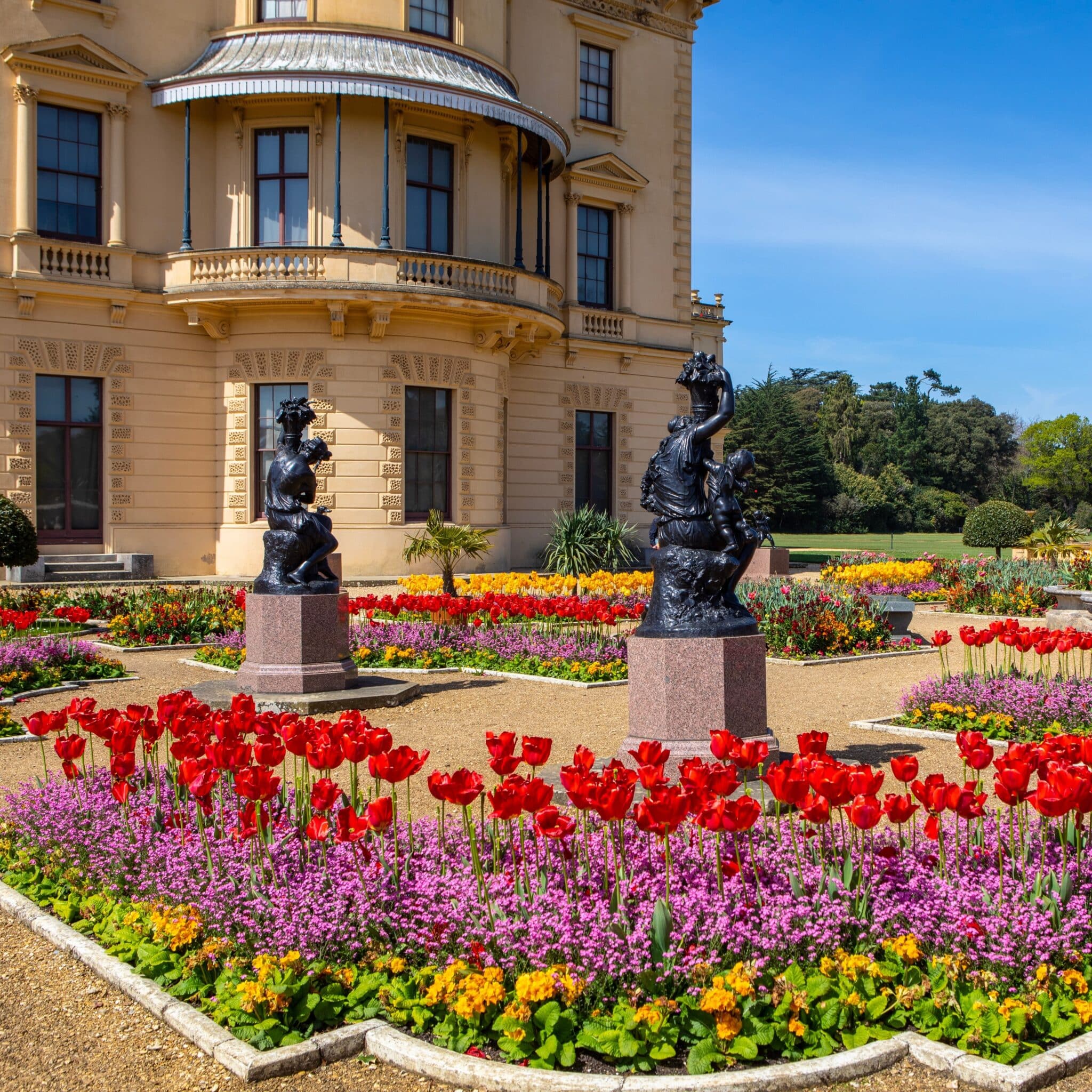 building, with colourful flowers on an terrace